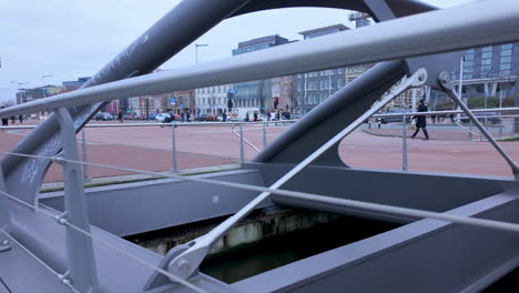 Urban-view-of-Amsterdam-with-graffiti-marked-railing-in-the-foreground