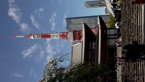 Visitors-Climbing-Stairs-Towards-Zojo-ji-Temple-With-Tokyo-Tower-And-Azabudai-Hills-Building-In-Background