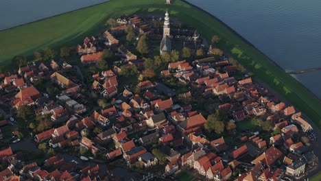 Aerial-drone-view-of-small-village-with-orange-roofs,-Hindeloopen,-Friesland