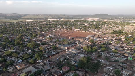 Stunning-4K-aerial-footage,-a-push-in-and-tilt-downward-drone-shot-gracefully-unveils-the-scenic-beauty-of-a-rural-township-in-South-Africa