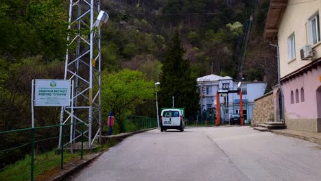 walking-into-the-'Levski'-hydroelectric-power-plant-court-by-the-'Suchurum'-waterfall-in-Karlovo,-Bulgaria