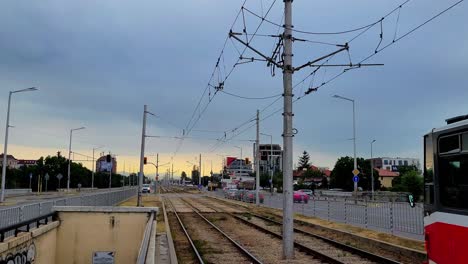 Red-Number-22-tram-and-traffic-passing-by-on-Botevgradsko-shose-Blvd