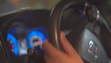 Closeup-shot-of-a-hand-of-a-Indian-man-on-a-Toyota-car-steering-driving-in-a-city-during-Night-time-in-India