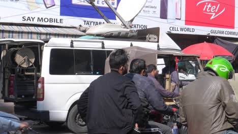 Shot-of-people-going-to-their-work-through-jammed-Saddar-Bazar-Street-during-afternoon-on-winter-in-Karachi,-Pakistan