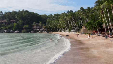 Aerial-Low-Flying-Over-Sairee-Beach-With-Holiday-Makers-In-background