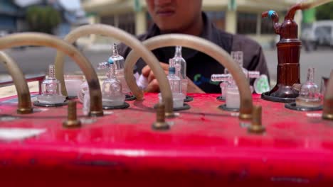 A-technician-is-pouring-liquid-into-a-glass-tube-on-a-machine