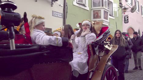 A-horse-drawn-carriage-drives-through-the-main-shopping-alley-during-Christmas-in-Klausen---Chiusa,-South-Tyrol,-Italy