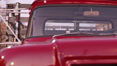 Red-antique-Ford-truck-on-the-corner-in-Winslow,-Arizona-with-pan-from-hood-to-lights