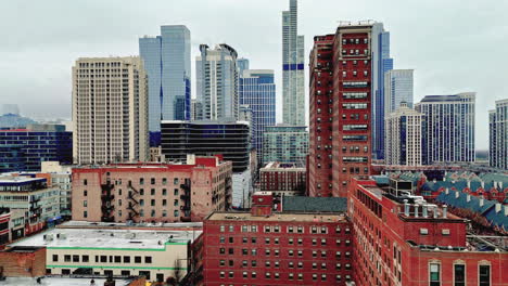 Aerial-view-ascending-in-front-of-high-rise-in-the-South-Loop,-in-foggy-Chicago