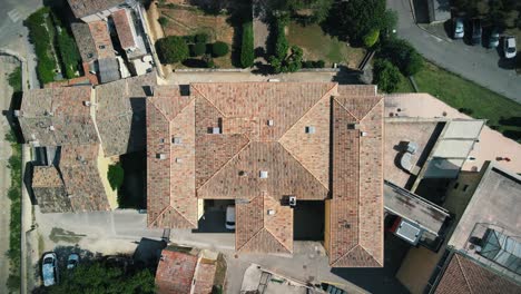 Ascending-bird's-eye-aerial-view-of-a-fancy-estate-with-swallowtails-in-Provence,-France