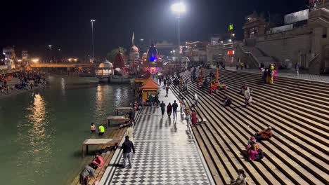 pov-shot-Many-people-are-coming-to-sit-near-the-river-Ganga-after-visiting-the-temple