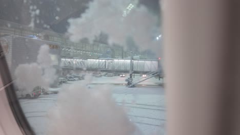 Ice-Falling-On-Window-Surface-Of-Airplane-At-Munich-Airport-In-Winter