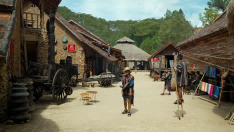 Ethnic-Cu-Lan-Village-Street---Vietnamese-Performers-in-Traditional-Costumes-Entertain-Tourists-Playing-on-Old-Instruments,-Da-Lat-City,-Vietnam