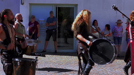 Drummers-parade-through-the-streets-of-the-village-at-the-South-Tyrolean-medieval-Games,-hand-held