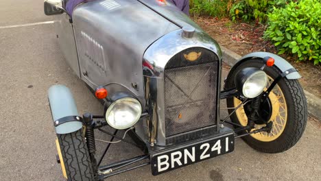 Classic-old-antique-silver-racing-car,-vintage-cars-at-a-parking-in-England,-expensive-collectible-cars,-single-seat,-4K-shot