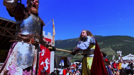 A-fighting-scene-with-weapons-performed-by-Burdyri,-a-professional-sword-and-stage-combat-team,-during-the-South-Tyrolean-Medieval-Games-2023,-hand-held