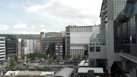 Japanese-city-business-offices-and-traffic-outside-rail-station-Karasuma