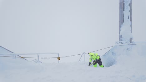 Worker-Shoveling-Snow-Off-Building-Stairway-On-Zugspitze-Mountain-In-Germany