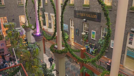 Top-angle-interior-view-of-Famous-Powerscourt-center-decorated-for-Christmas-with-artificial-plants-and-lights-during-December-in-Dublin,-Ireland