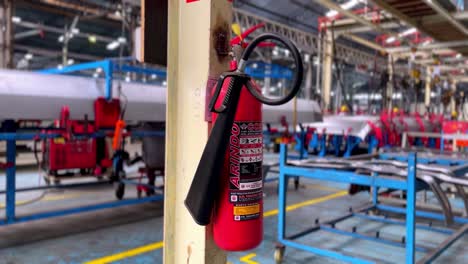 Fire-extinguisher-attached-to-warehouse-pole