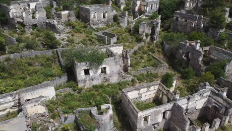 Drone-panning-from-the-right-to-the-left-above-the-abandoned-houses-of-Kayaköy,-a-UNESCO-World-Friendship-and-Peace-Village-in-Turkey