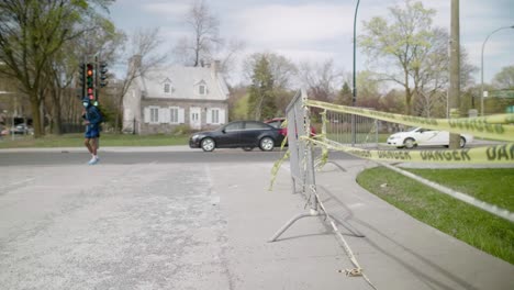 Yellow-Danger-Tape-Moving-In-Wind-Tied-To-Metal-Railings-Outside-In-Street-In-Montreal