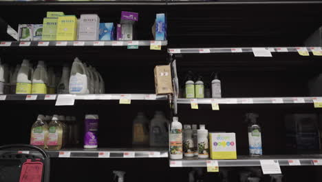 Half-empty-cleaning-product-shelves-at-Wholefoods-tilt-down