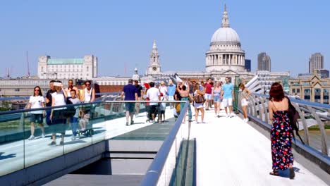 Pre-Pandemia,-Vida-Normal-En-Londres,-Lugareños-Y-Turistas-Que-Visitan-El-Puente-Del-Milenio---Toma-Estática-Mirando-La-Catedral-De-San-Pablo-Con-Peatones-Cruzando-El-Puente-Tambaleante,-Horario-De-Verano-De-Gran-Bretaña-Reino-Unido