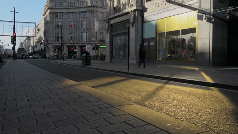 London-in-Covid-19-Coronavirus-lockdown-with-quiet-empty-roads-at-Oxford-Street-and-Oxford-Circus,-with-closed-shops-shut-down-at-the-popular-shopping-high-street-in-the-pandemic-in-England,-Europe