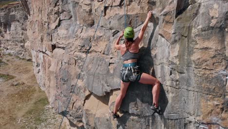 Closeup-of-Outdoor-Rock-Climber-Removing-Anchor-Attachment-and-Carabiner