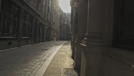 One-person-commuting-on-an-electric-scooter-in-London-in-empty-roads-and-quiet-streets-during-Coronavirus-pandemic-Covid-19-lockdown,-taken-at-rush-hour-at-Bank-in-the-City-of-London,-England,-Europe