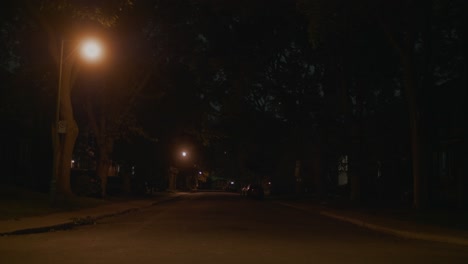 Dark-Lit-Empty-Road-In-Montreal-With-With-Car-Going-Past-In-The-Distant