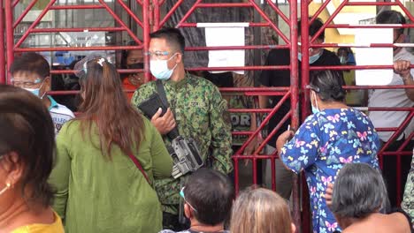 Heavily-armed-Filipino-police-keep-order-at-a-Covid-19-vaccination-station-in-Surigao-City-Philippines