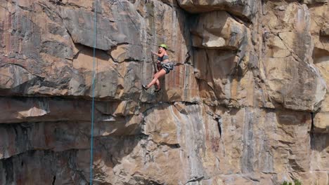 Rock-Climber-Removing-Anchor-.-Smooth-Drone-Closeup