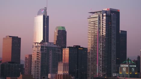 Aerial-view-of-high-rise-in-Downtown,-Los-Angeles,-California,-USA,-colorful-dusk-sky---rising,-drone-shot