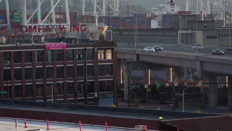 Seattle,-Washington-USA,-Traffic-on-State-Highway-99-With-Shipping-Containers-Terminal-in-Background