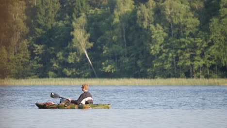 Hombre-Con-Un-Solo-Kayak-En-El-Lago-En-Una-Tarde-Soleada.