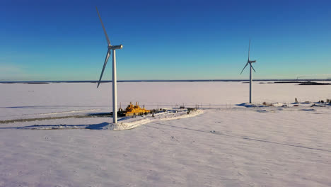 Aerial-drone-view-of-windmills-and-a-ferry-at-the-Oulunsalo-lauttasatama,-in-Oulu,-Finland