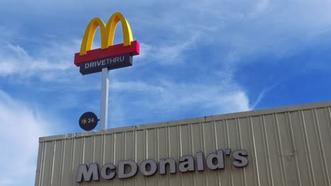 Señalización-Con-El-Logotipo-De-McDonald&#39;s-Drive-thru-M-En-Lo-Alto-De-La-Entrada-De-La-Azotea-Contra-El-Fondo-Del-Cielo-Azul