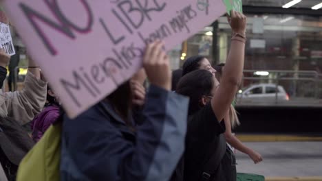 Women-are-holding-up-signs-with-protest-messages-and-singing-as-they-march-during-the-International-Women's-day-in-Quito-Ecuador