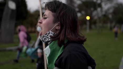 A-woman-is-fiercely-chanting,-singing-and-protesting-as-she-marches-with-crutches-during-the-International-Women's-day-in-Quito-Ecuador