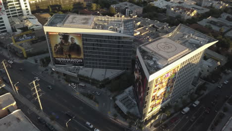 Aerial-View-of-West-Hollywood-Buildings-With-Heliports,-Movie-Billboards-and-Traffic-on-Sunset-Boulevard,-California-USA,-Drone-Shot