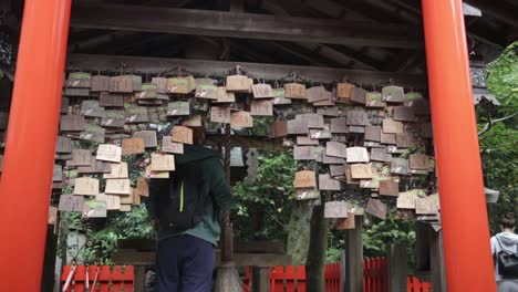 Tourist-entering-the-bell-temple-at-the-Kyoto-park-and-rings-the-bell-for-luck