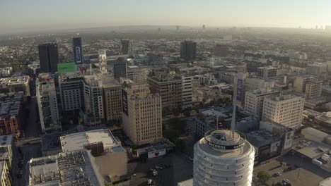 Aerial-View-of-Capitol-Records-Building,-Hollywood-Boulevard-and-Misty-Skyline-of-Los-Angeles-CA-USA