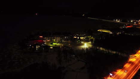 Aerial-view-toward-the-Tropiclandia-waterpark-and-hotel,-night-in-Vaasa,-Finland