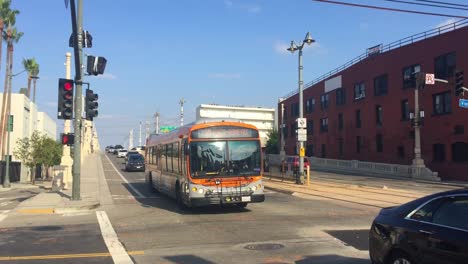 Traffic-driving-across-the-North-Alameda-Street-bridge-and-crossing-East-1st-Street-in-Los-Angeles-arts-district-in-California-on-a-sunny-summer-day