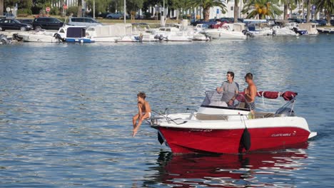 Boat-with-kid-on-the-front-edge,-slow-motion