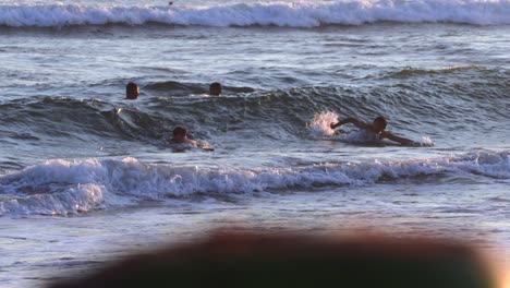 Niños-Felices-Nadando-Sobre-Las-Olas-Del-Océano-Al-Atardecer,-Cámara-Lenta