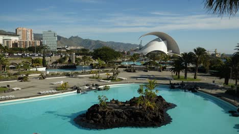 Parque-Maritimo,-Cesar-Manrique,-Water-Park-with-the-Auditorium-in-background,-Part-one