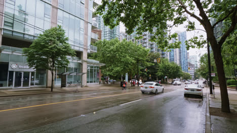 Vehicles-Driving-On-Wet-Asphalt-Street-On-Rainy-Weather-In-Downtown-Vancouver,-Canada